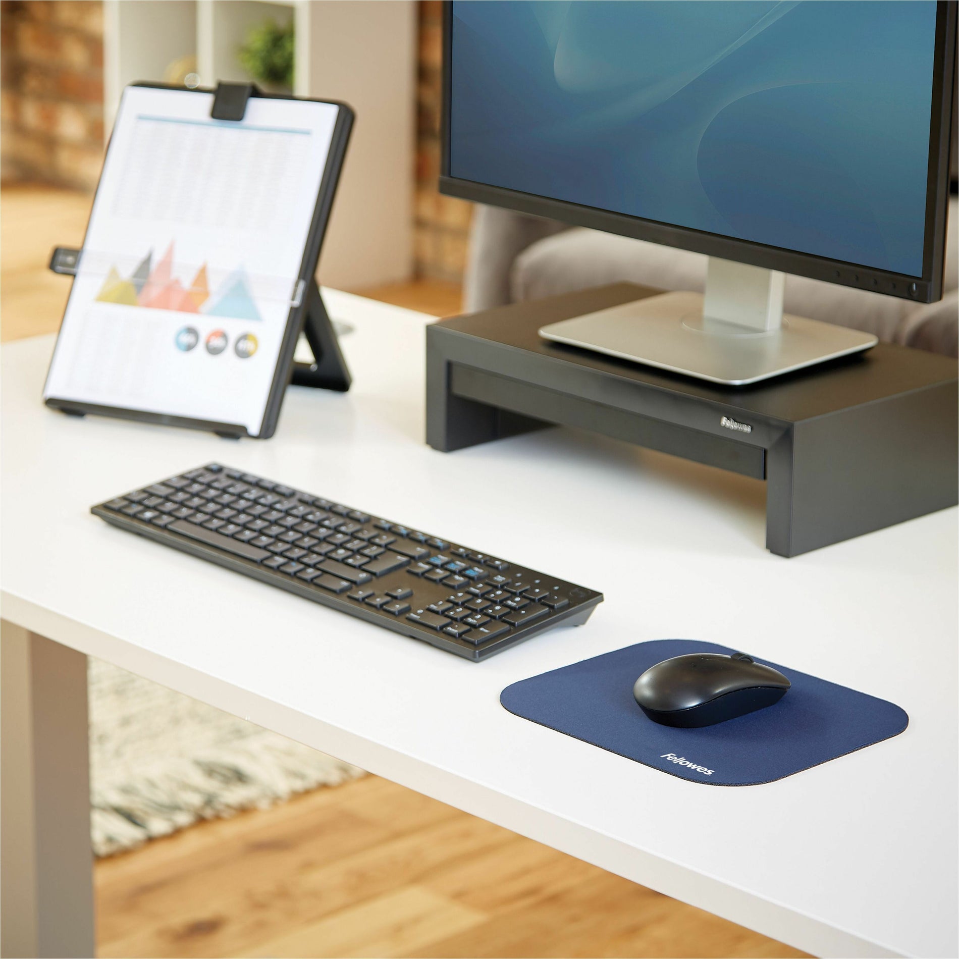 Fellowes mouse pad shown in a modern office setup with keyboard, monitor, and document holder-alternate-image3