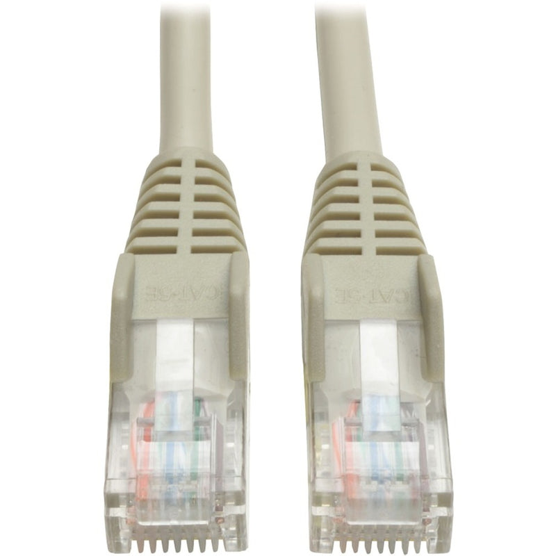 Close-up view of two RJ45 connectors with snagless boots on Tripp Lite Cat5e patch cable showing transparent housing and internal wiring