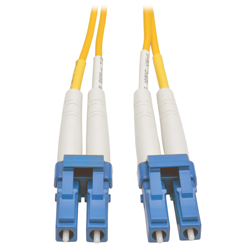 Close-up view of blue LC connectors on yellow singlemode fiber optic patch cable with white strain relief boots