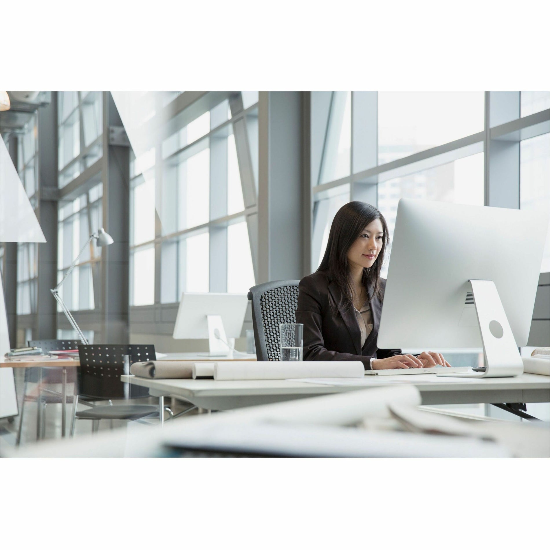 Modern office setting with large windows showing computer monitor with anti-glare filter reducing window reflection-alternate-image2