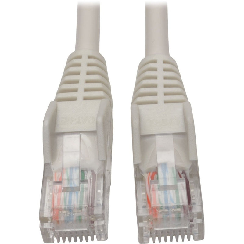 Close-up view of white Cat5e cable RJ45 connectors showing gold-plated pins and color-coded internal wiring