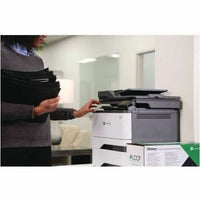 Office worker operating Lexmark printer with stack of documents for printing-alternate-image4