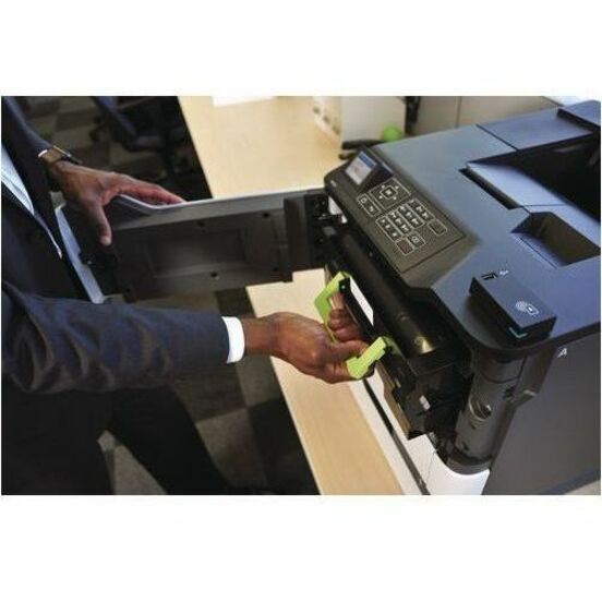 Close-up of hands installing paper tray into Lexmark printer