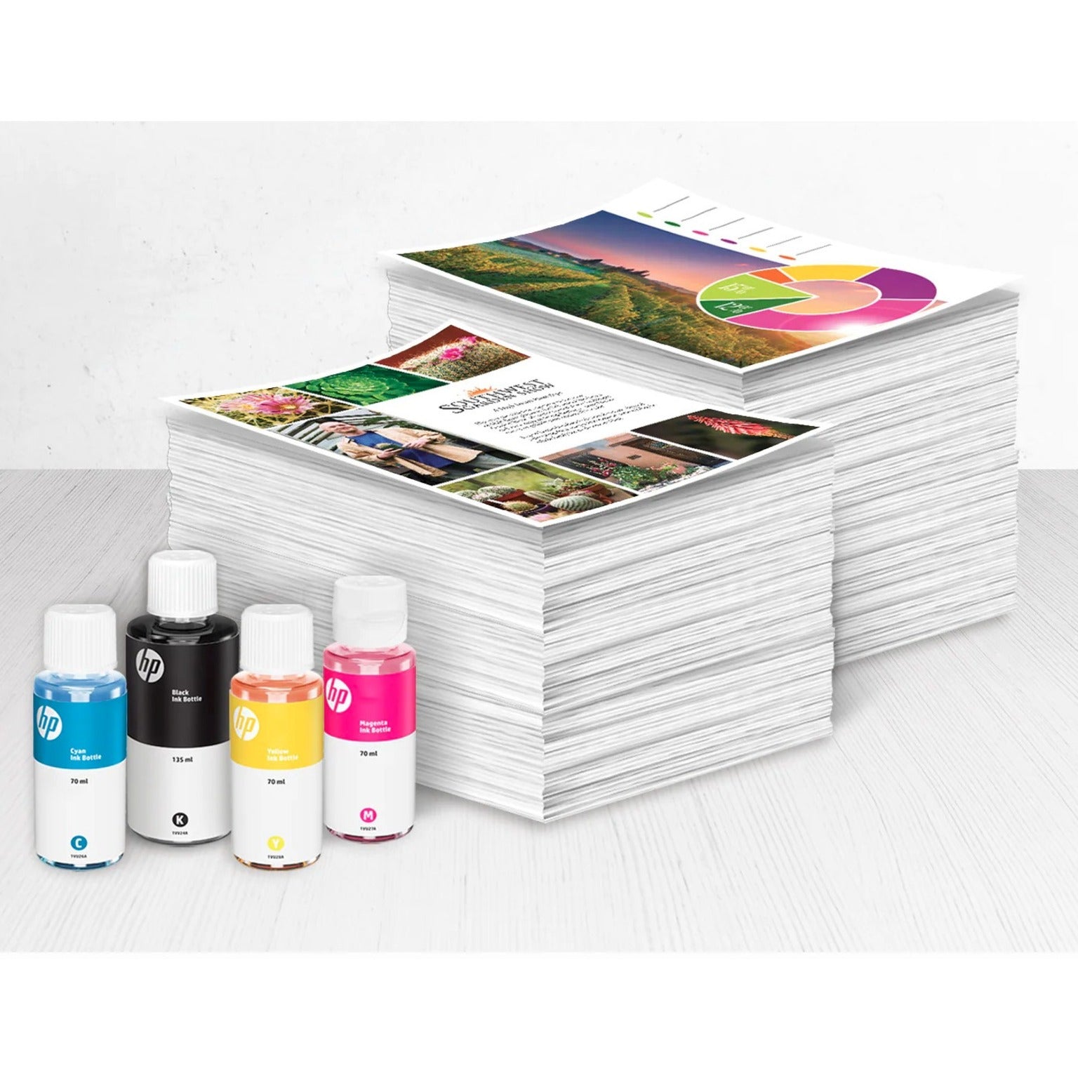 HP ink bottles displayed with stacks of printed materials showing print quality-alternate-image4