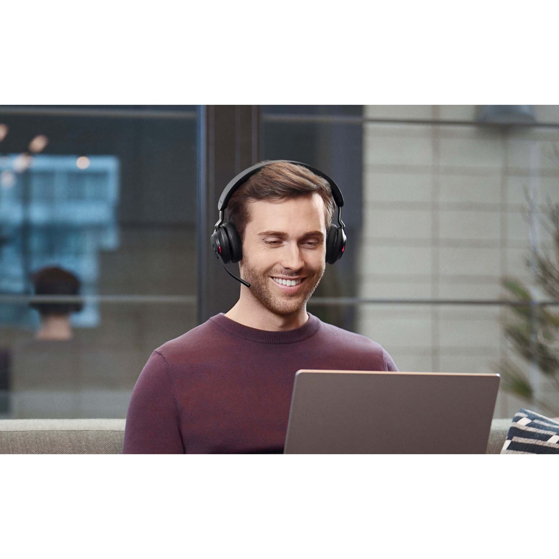 Professional using Jabra Evolve2 65 headset with laptop-alternate-image7