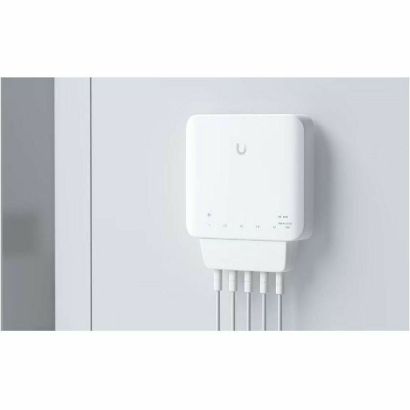 UniFi Switch Flex mounted vertically on a wall with connected cables