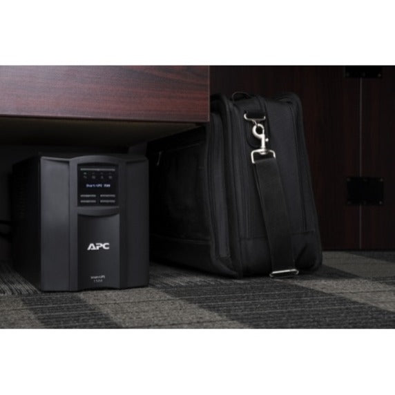 APC Smart-UPS placed in an office setting under a desk with business accessories-alternate-image3