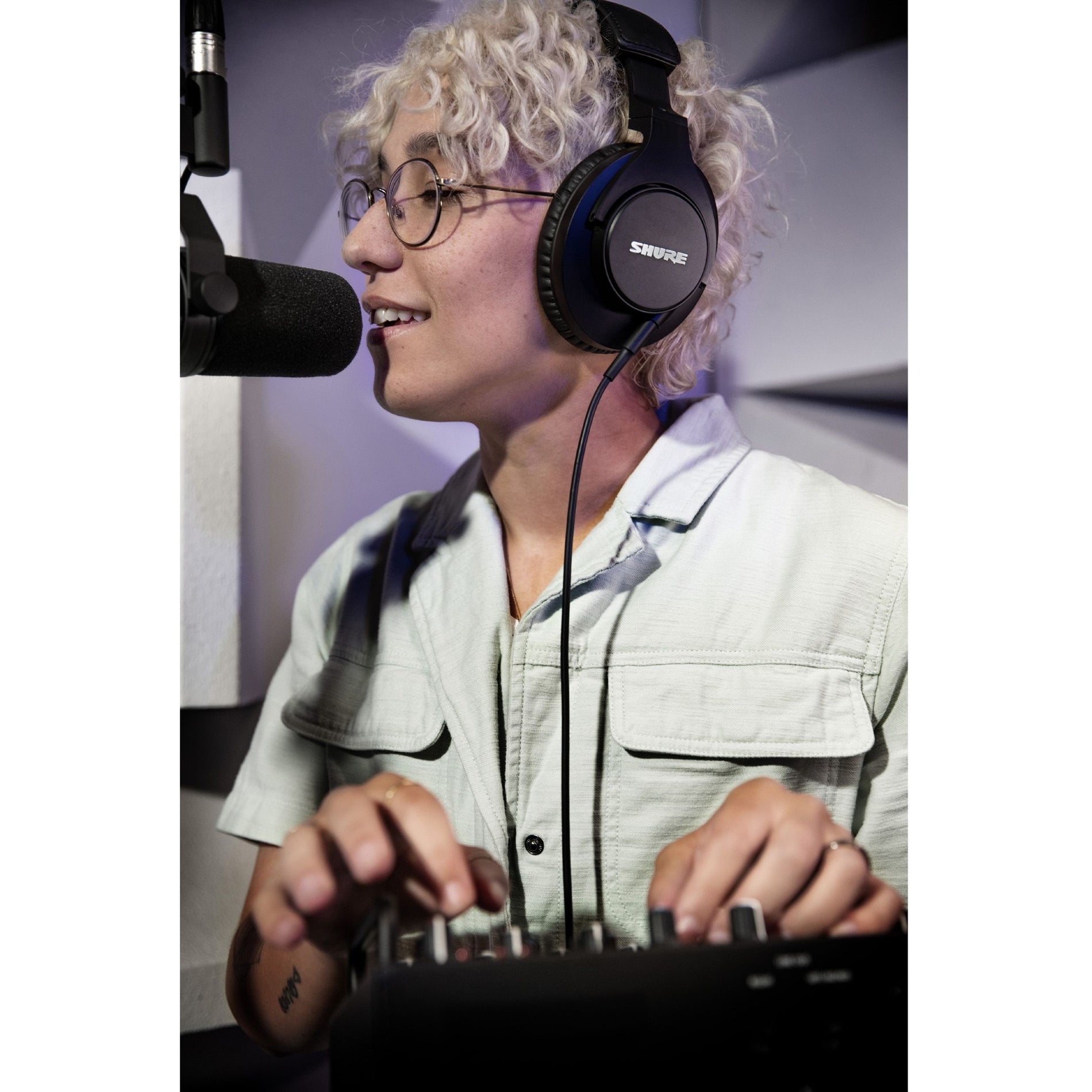 Content creator using Shure SRH440A headphones in a studio setting-alternate-image11