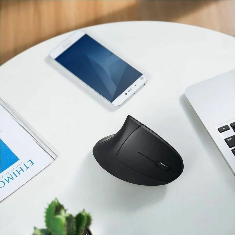 Vertical mouse in modern office setting alongside smartphone and laptop