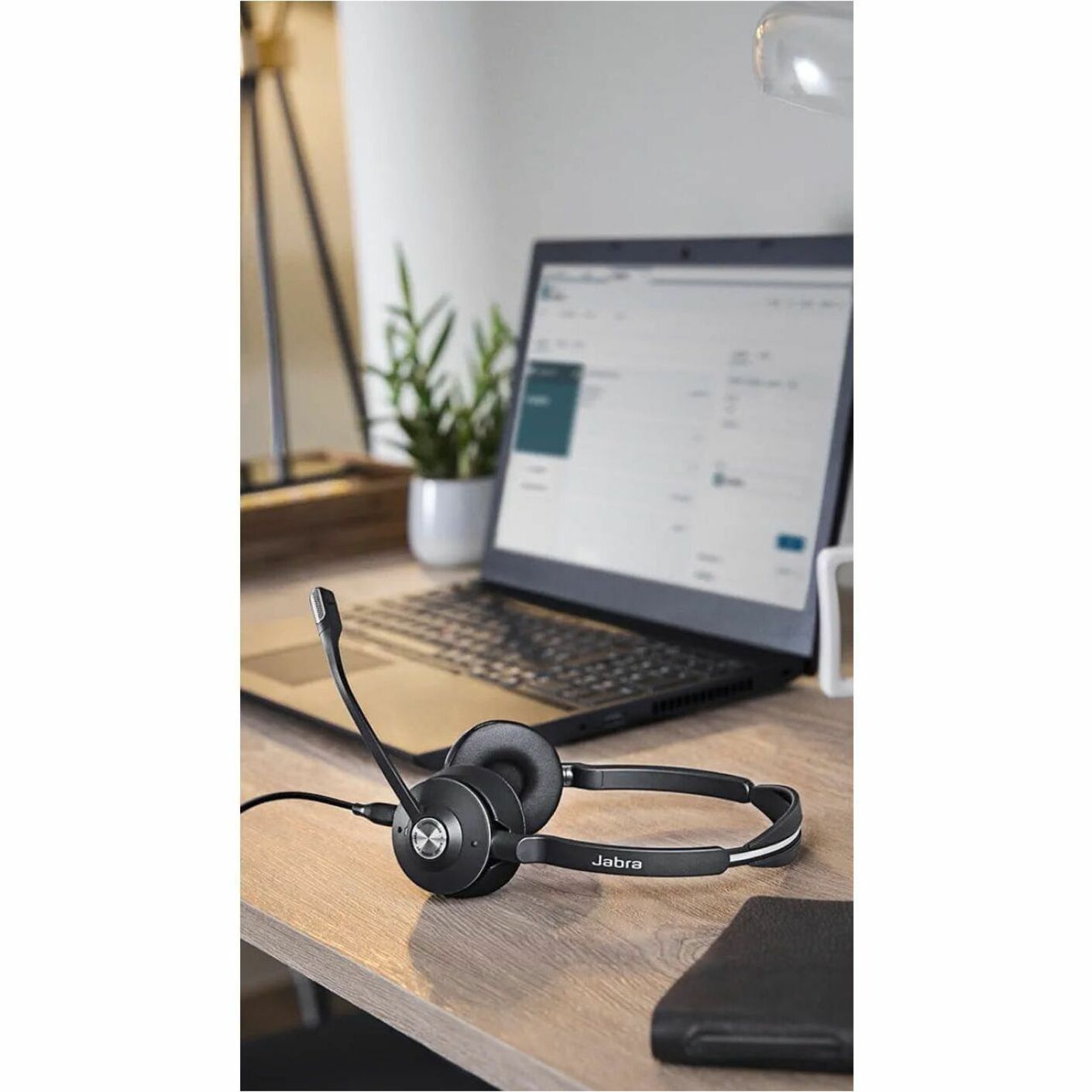 Jabra Engage 65 headset on desk with laptop and modern office setup-alternate-image4