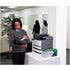 Office worker reviewing printed documents next to a Lexmark printer with toner supplies-alternate-image2