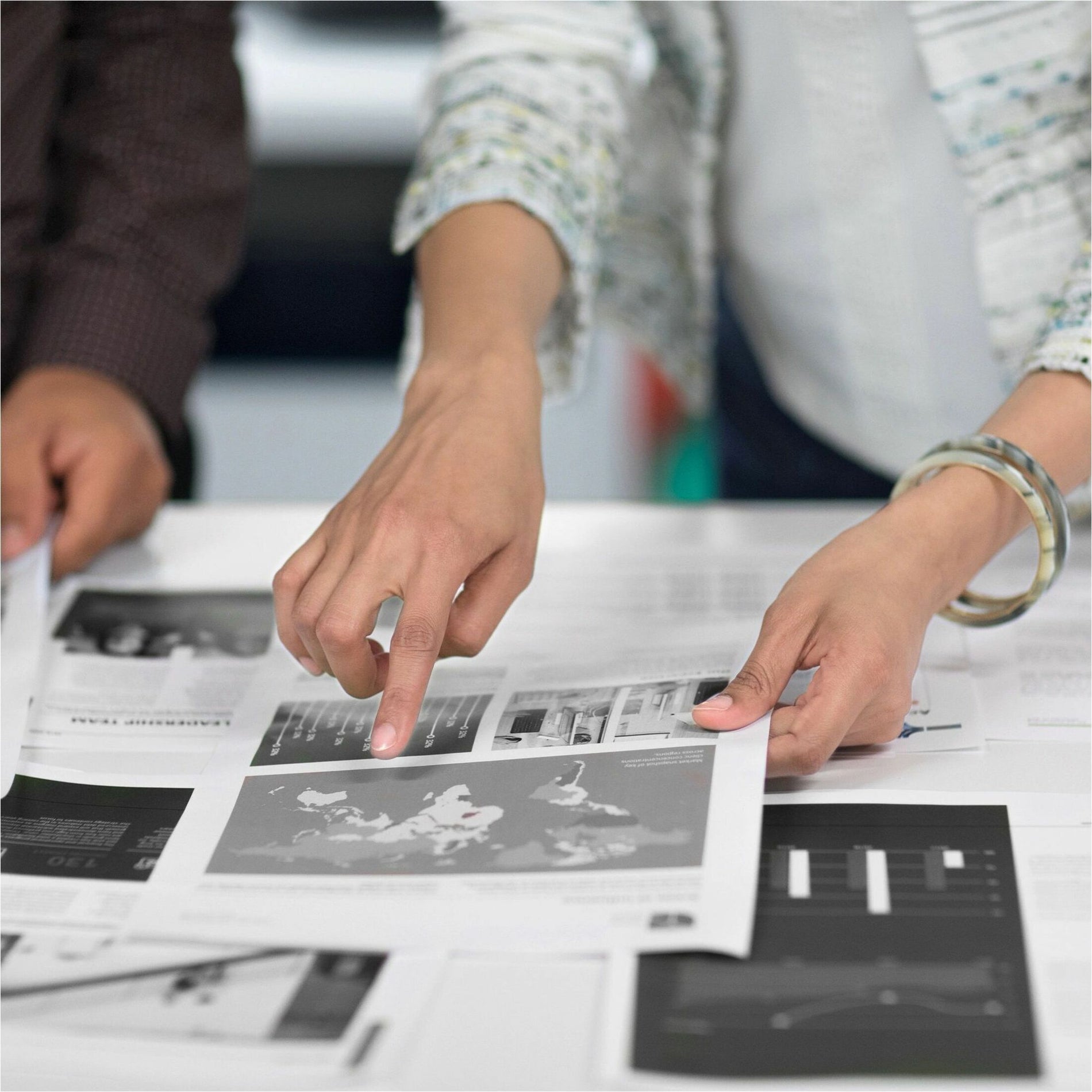 Close-up view of hands reviewing detailed printed materials-alternate-image3