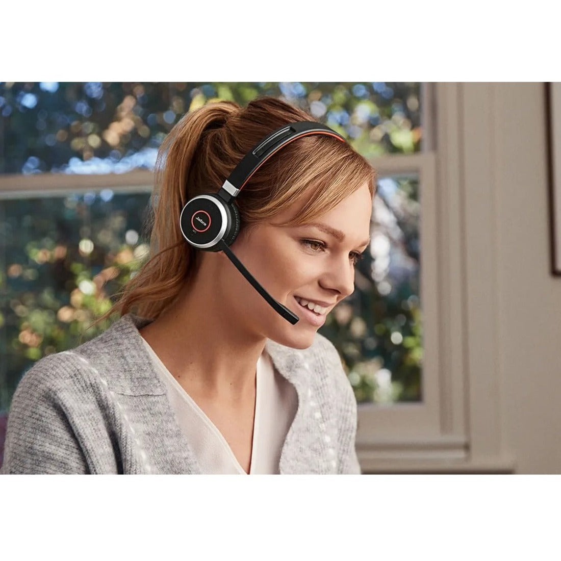 Person wearing Jabra Evolve 65 headset while working in home office environment-alternate-image5