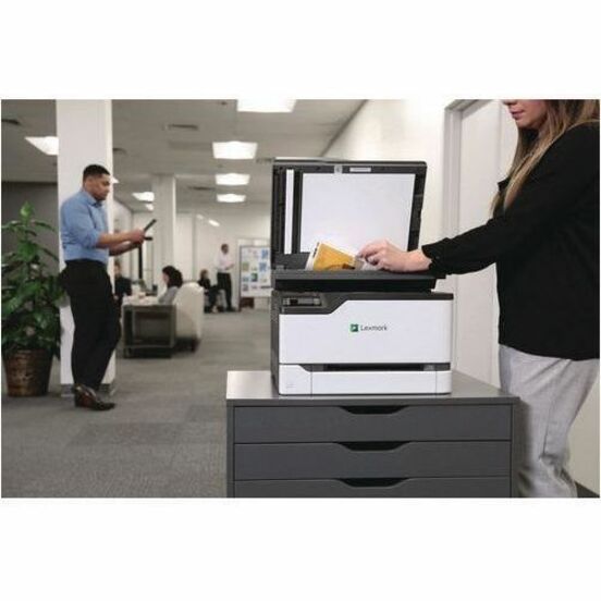 Business environment showing Lexmark printer in use with multiple office workers-alternate-image3