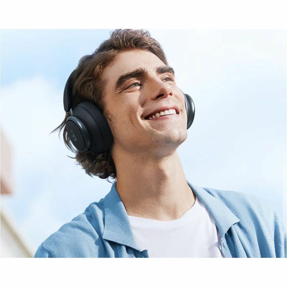 Upward angle shot of person enjoying music with Space Q45 headphones with a bright smile-alternate-image3