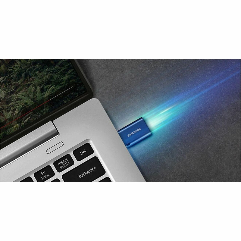 Samsung USB-C flash drive connected to laptop with blue light effect