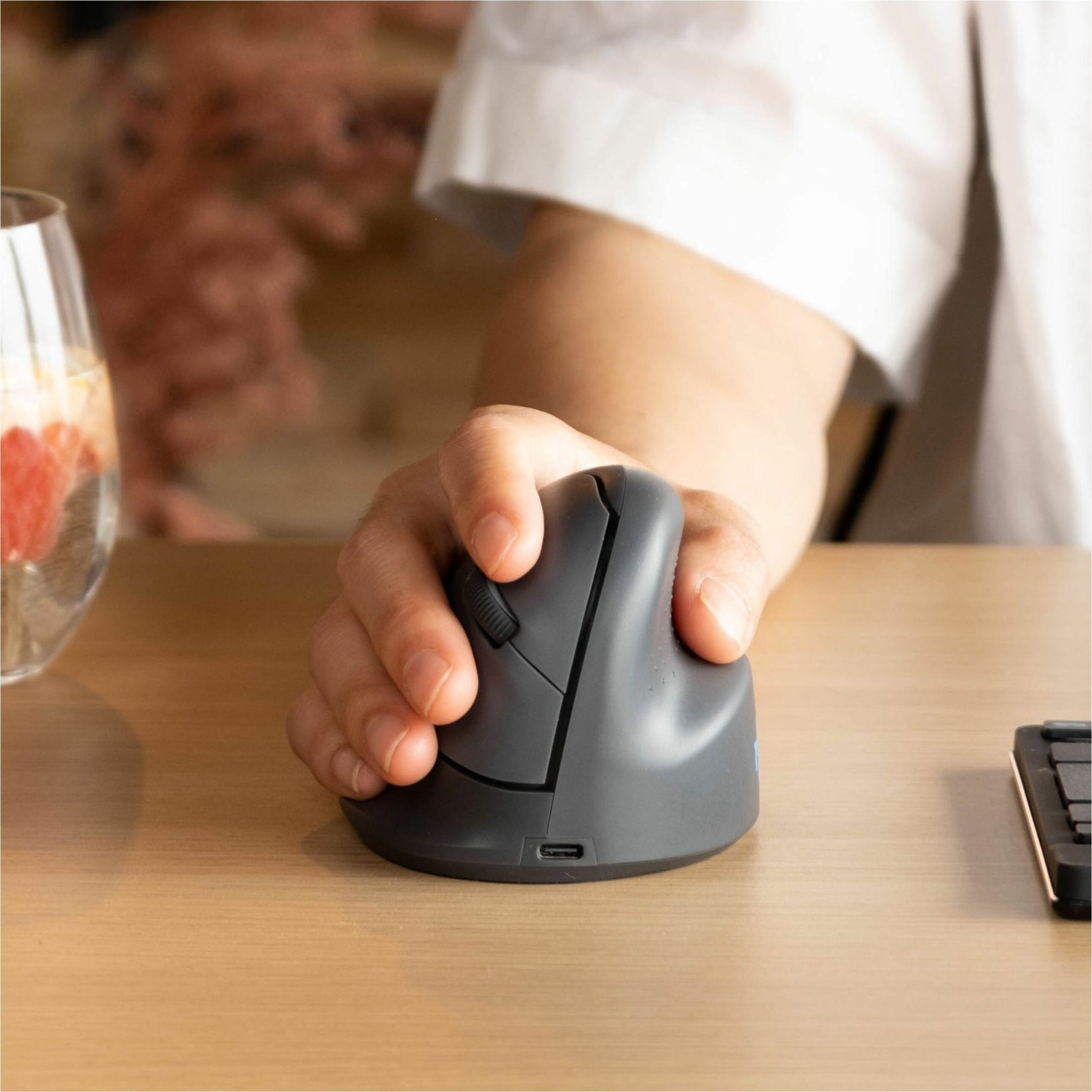 Close-up view of R-Go ergonomic mouse being used on wooden desk surface-alternate-image2