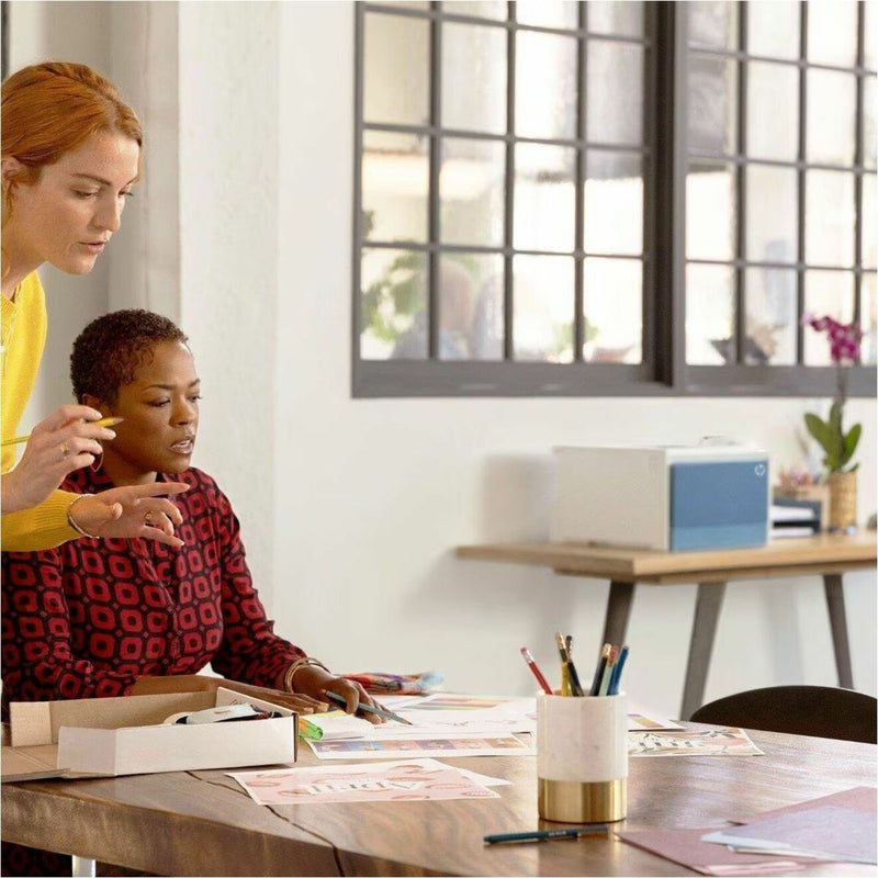 Office setting showing team members collaborating near the HP Color LaserJet Pro 4201dn printer