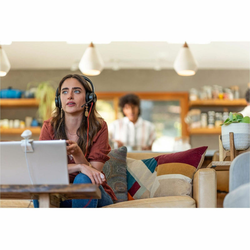 Person using Poly Blackwire headset in a casual workspace setting