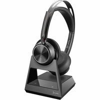 Poly Voyager Focus 2 headset on its charging stand showing power management solution-alternate-image4