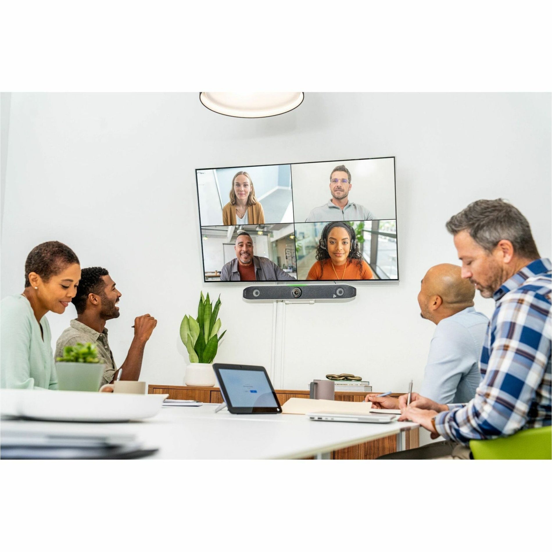 Active video conference showing multiple remote participants on screen with in-room participants-alternate-image3