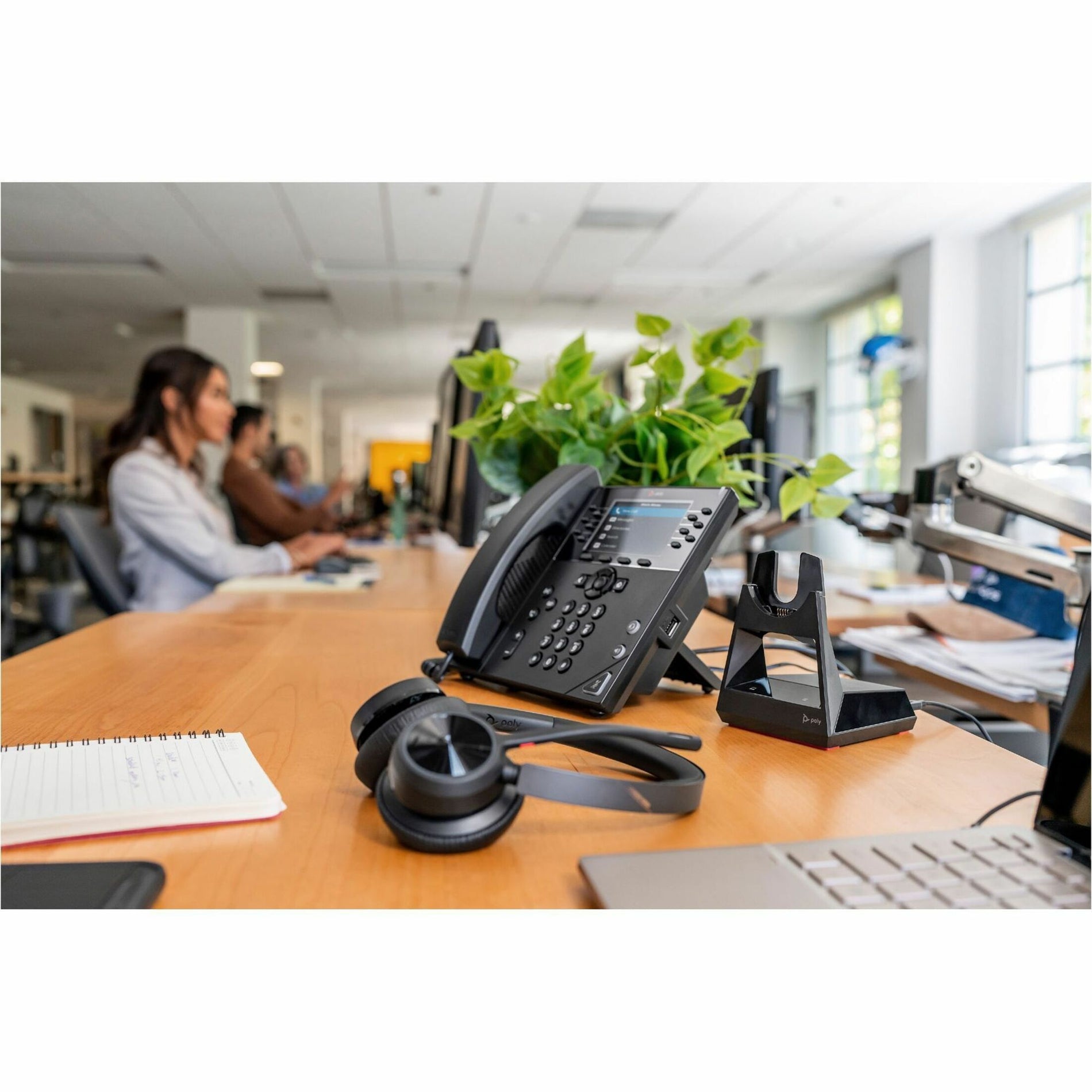 Poly Voyager 4320-M headset in modern office setting with desk phone-alternate-image8