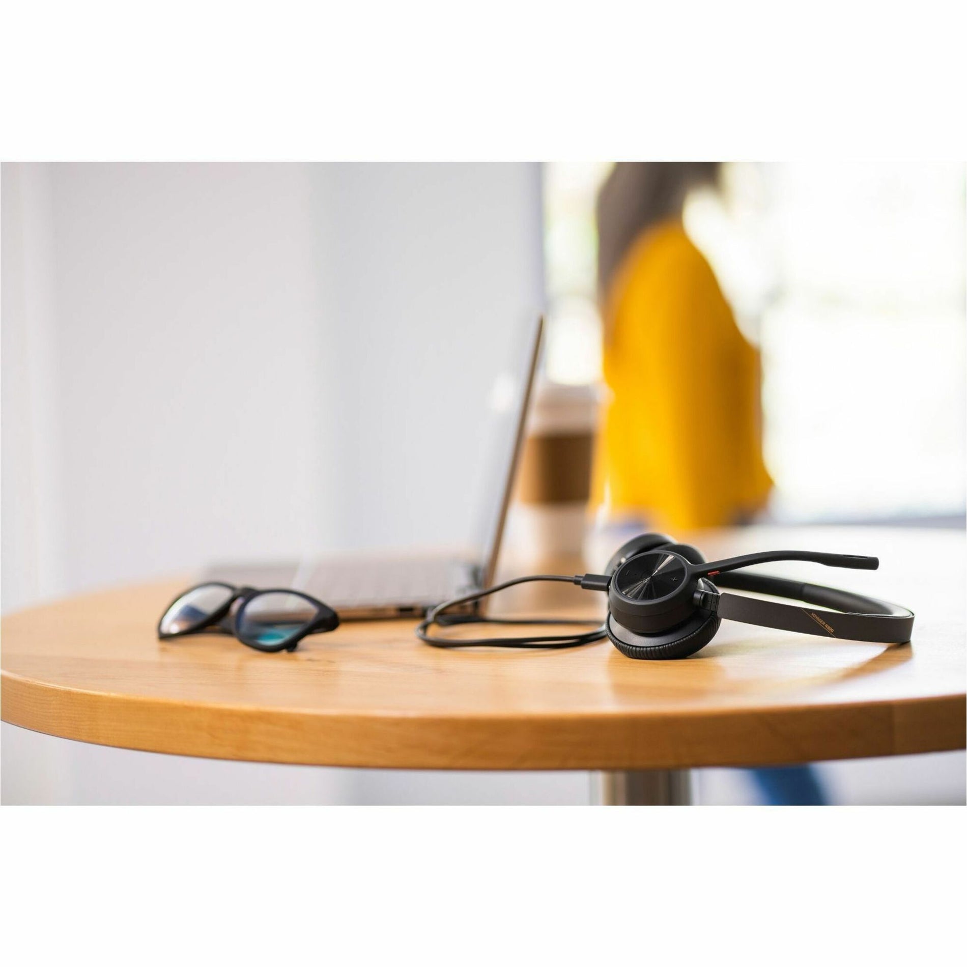 Poly Voyager 4320-M headset on office desk with accessories-alternate-image11