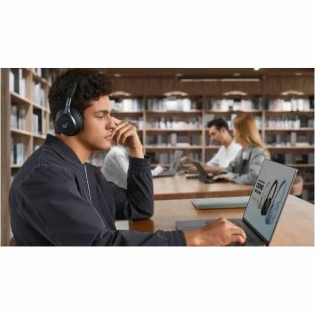 Person using Space One headphones while studying in a library setting-alternate-image9