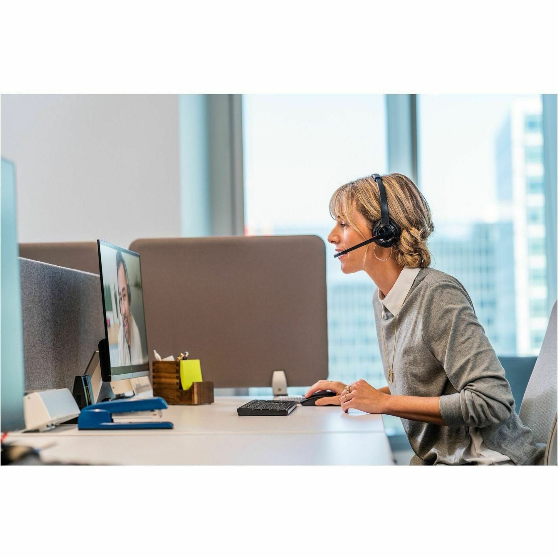 Professional using Poly Savi 8220 headset during virtual meeting in office setting-alternate-image5