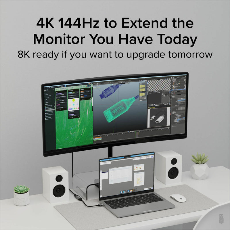 Modern workspace setup showing laptop connected to high-resolution monitor displaying 3D graphics