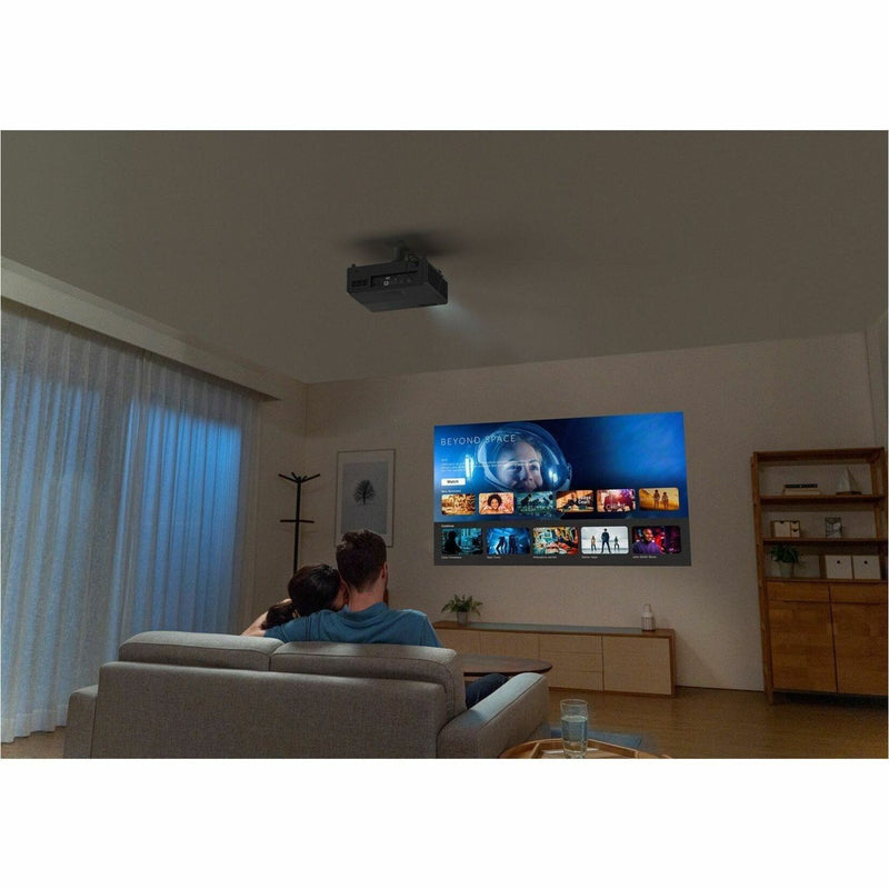 Real-world setup showing Optoma UHZ55 projecting movie content in home theater environment