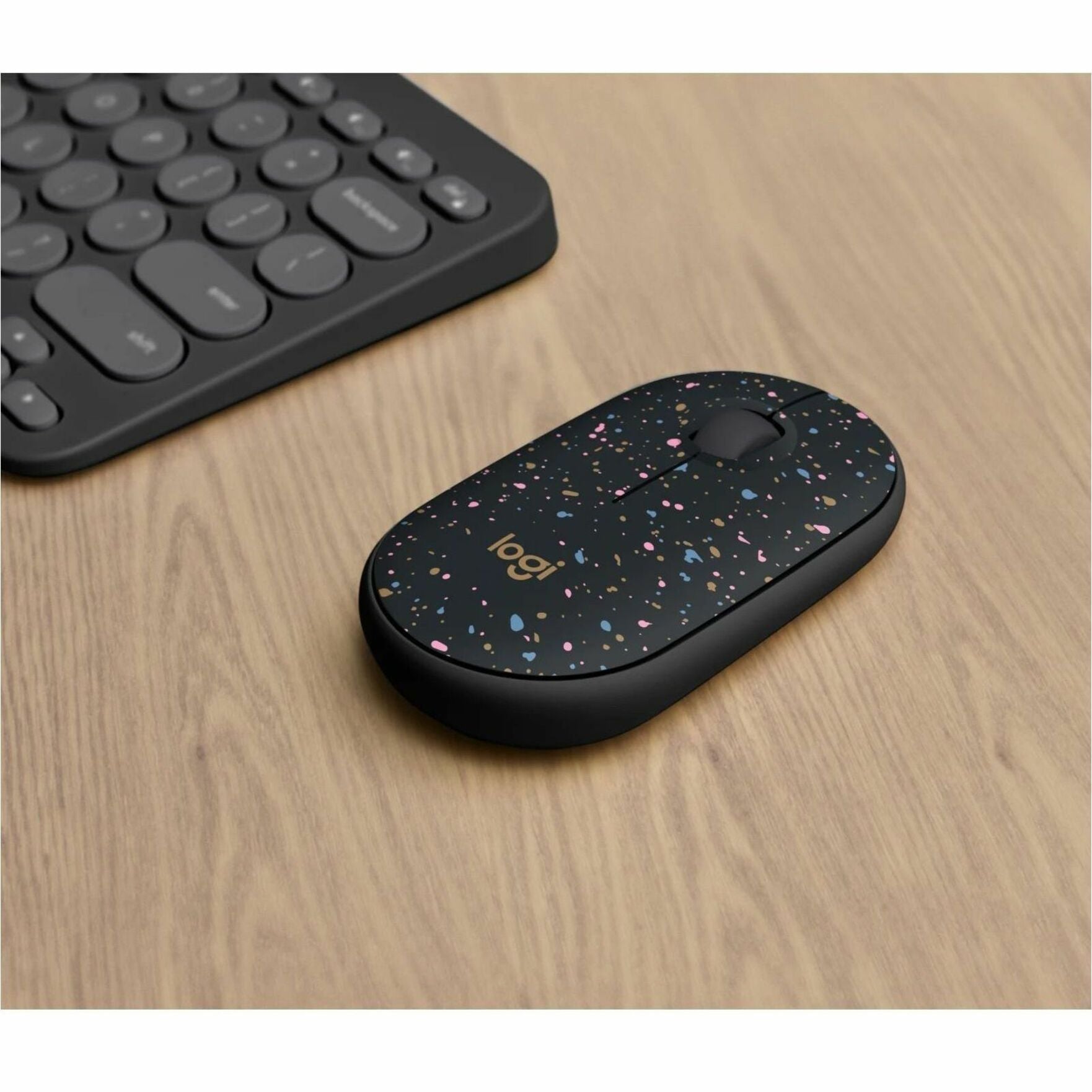 Logitech M340 wireless mouse shown on wooden desk next to keyboard-alternate-image6