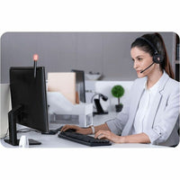 Professional using Yealink WH62 headset in modern office setting with busylight indicator-alternate-image4