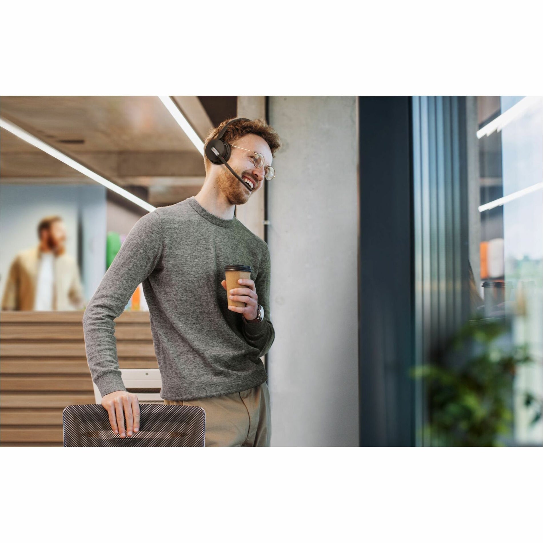 Professional using headset while standing in modern office space-alternate-image7