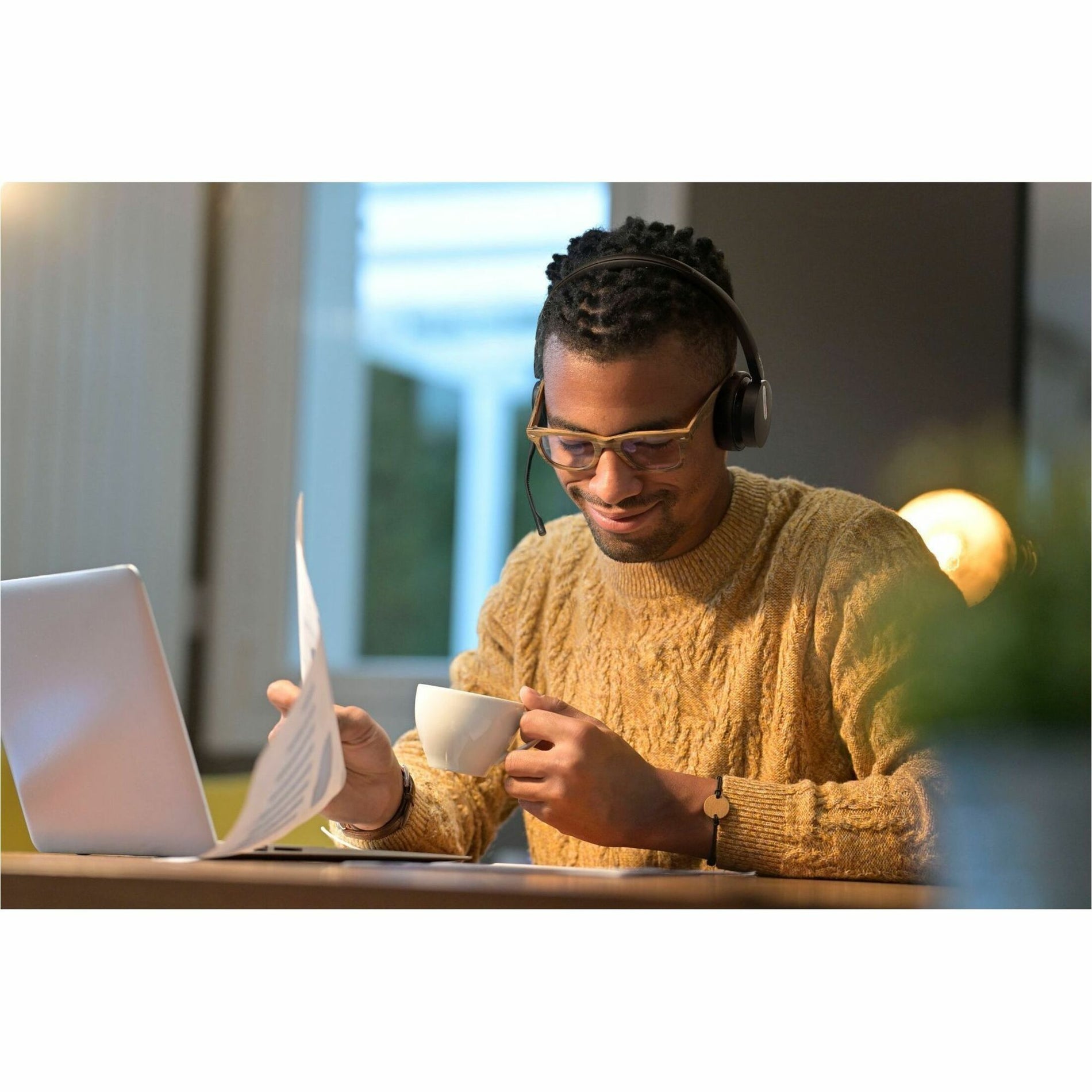 User working with laptop and headset in casual office setting-alternate-image6