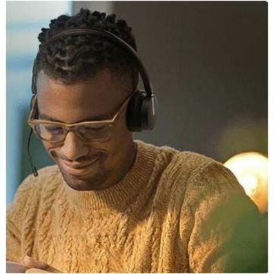 Person wearing Yealink BH70 headset while working in office environment-alternate-image6