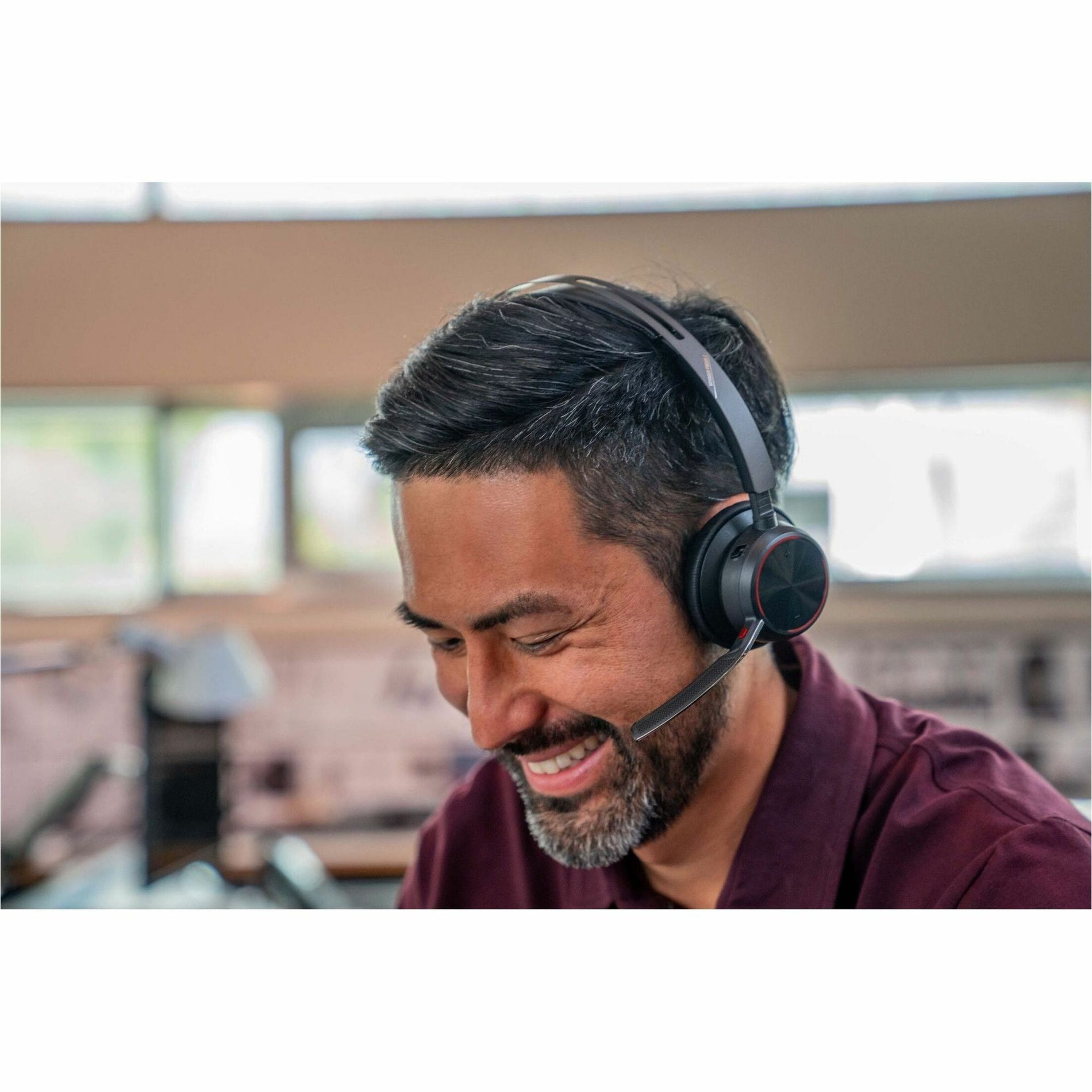 Professional using Poly Voyager Focus 2 headset in office environment-alternate-image6