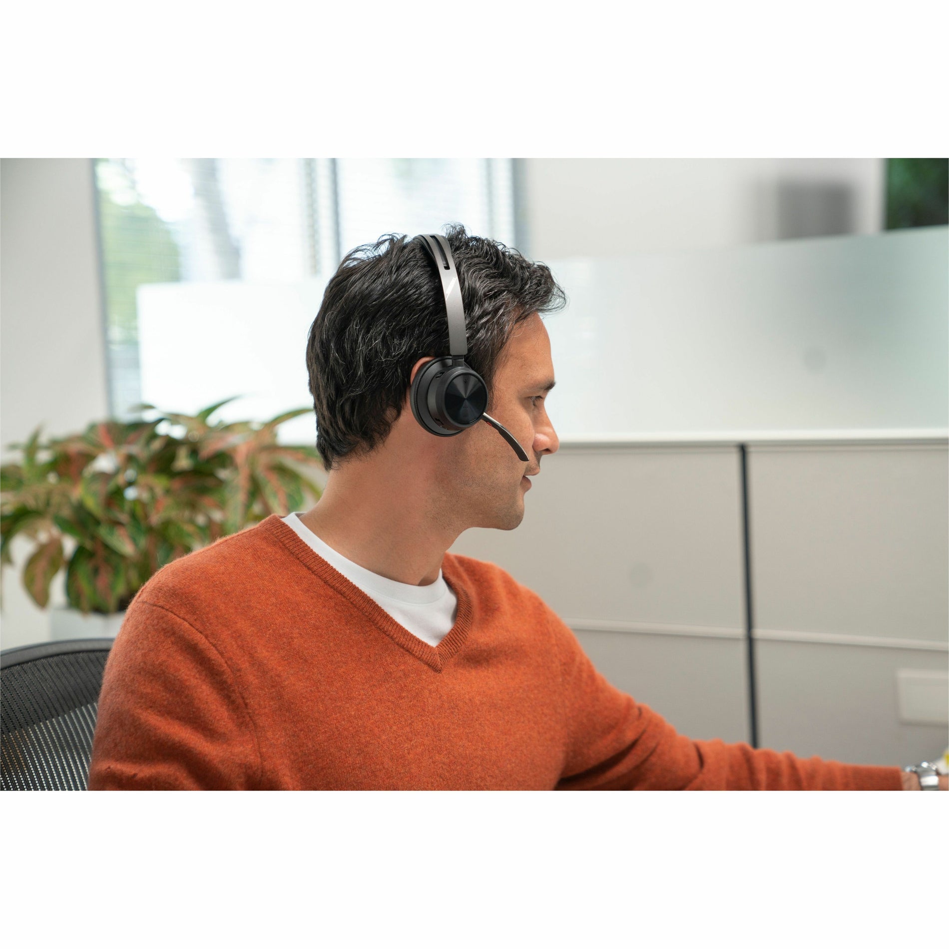 Professional wearing Poly Voyager Focus 2 headset in office environment-alternate-image6