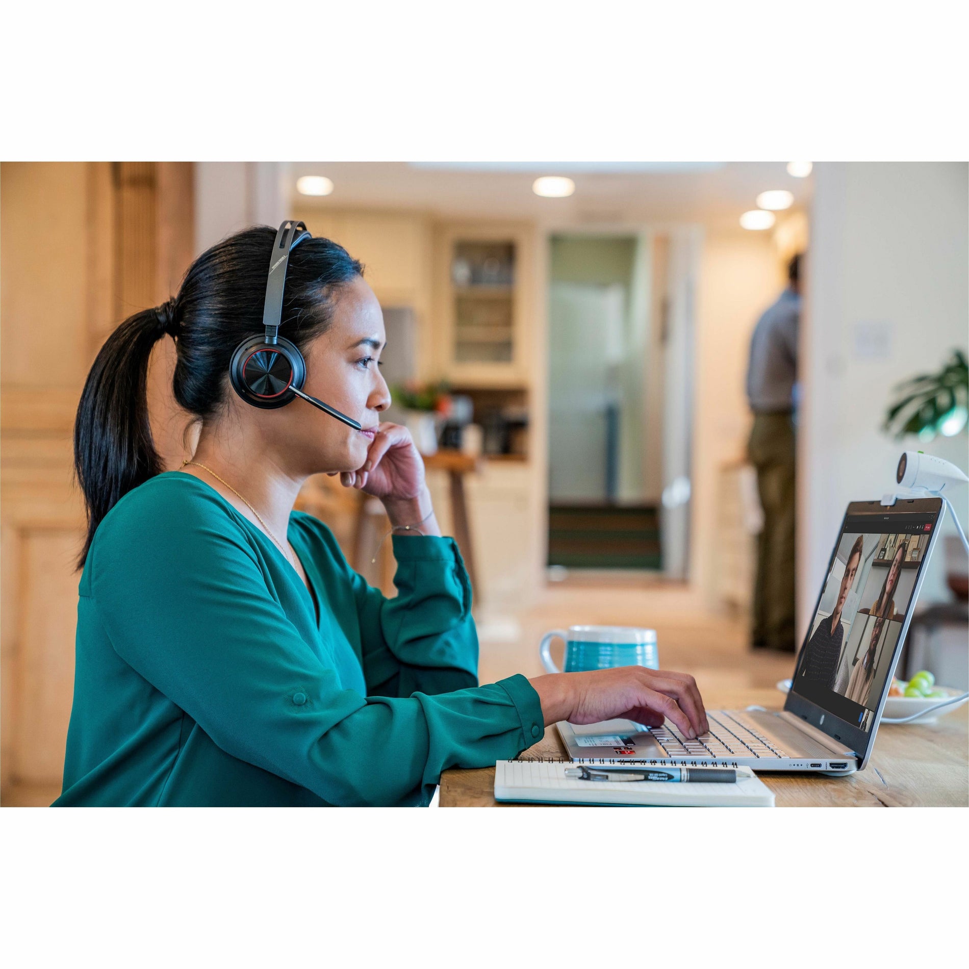 Professional engaged in virtual meeting using Poly Voyager Focus 2 headset-alternate-image9