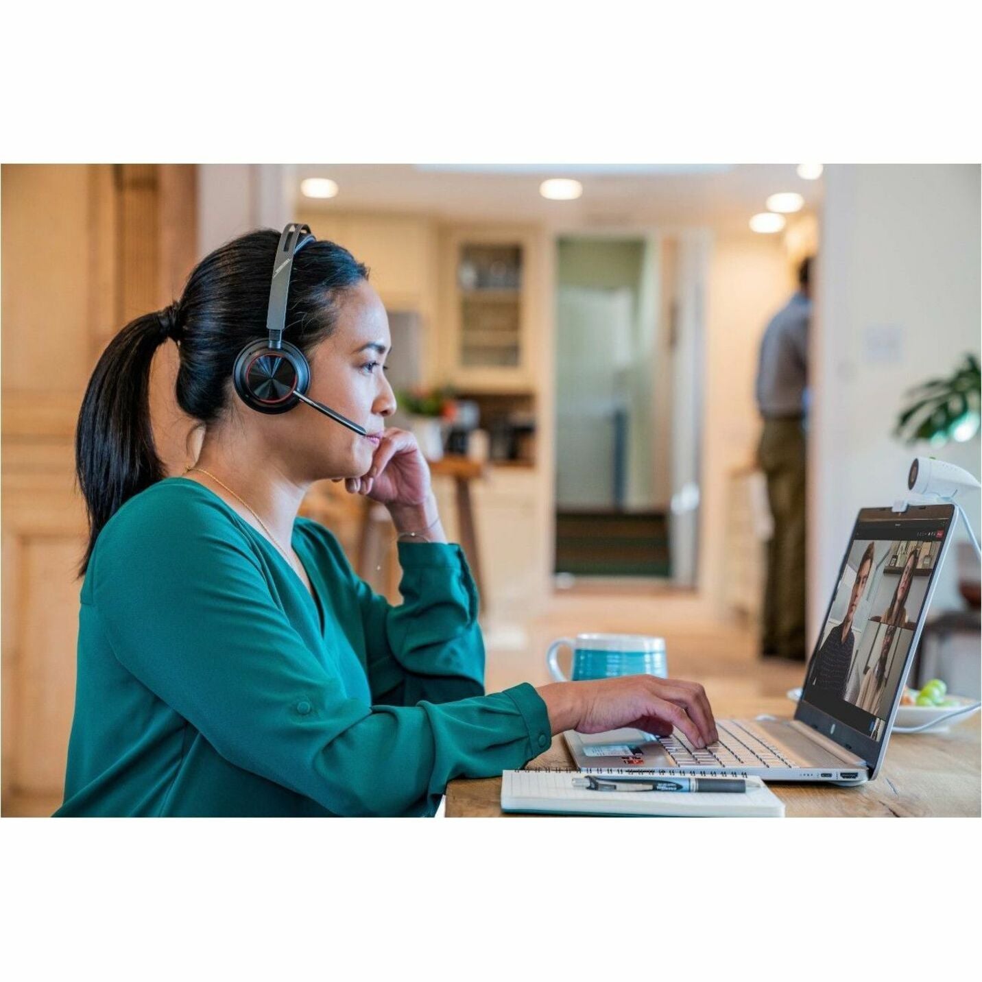 Poly Voyager Focus 2 headset in use in modern office-alternate-image12