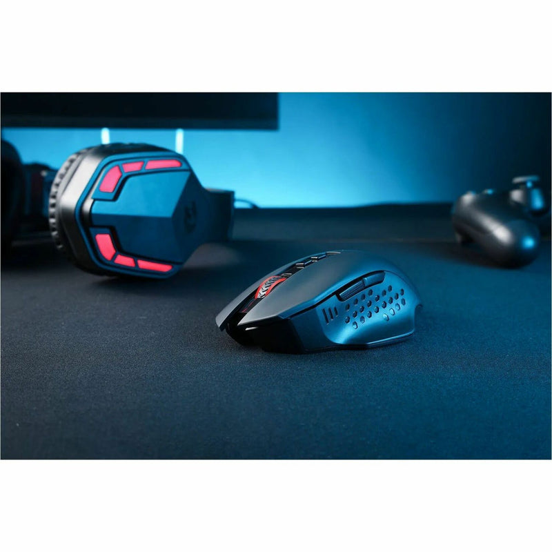 Artistic shot of Redragon M656 gaming mouse with dramatic lighting