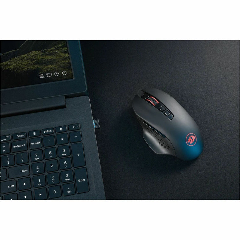 Redragon M656 gaming mouse next to laptop keyboard showing professional use case