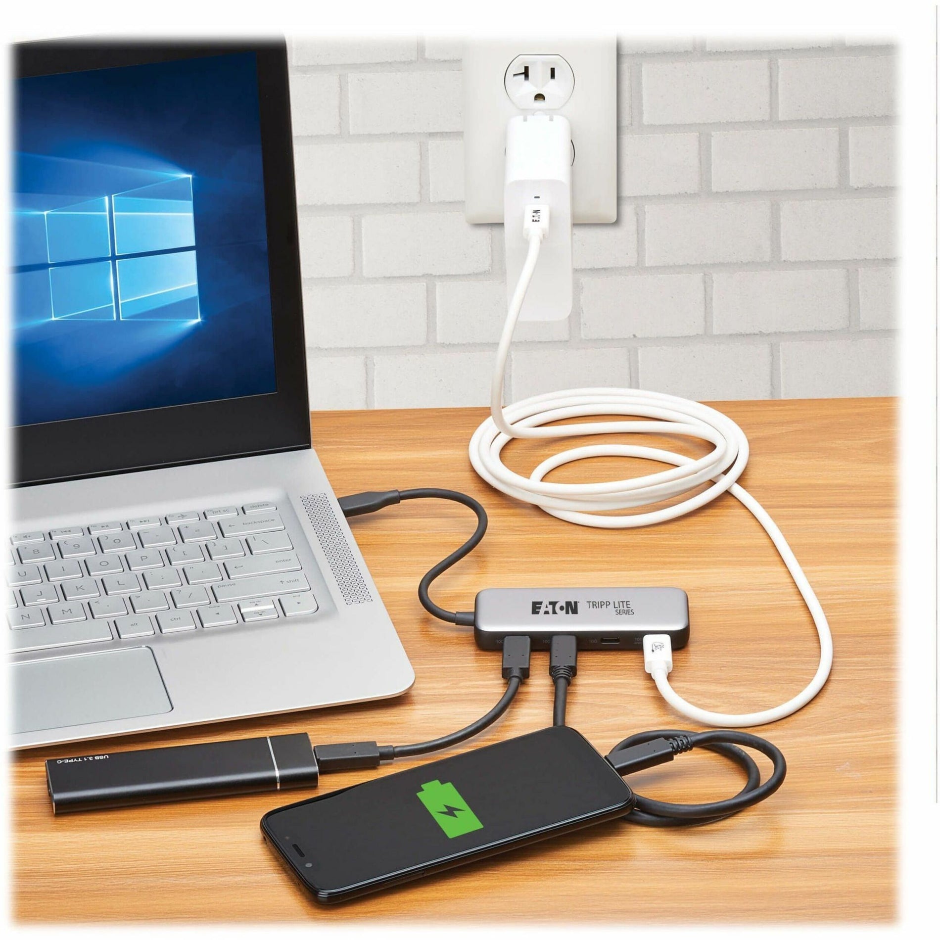 USB-C hub connected to laptop and smartphone showing simultaneous charging and data transfer capabilities-alternate-image1