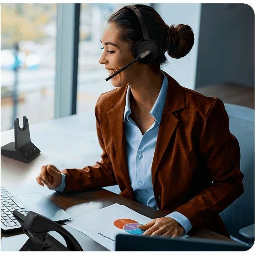 Professional wearing Yealink WH64 headset in office environment-alternate-image3