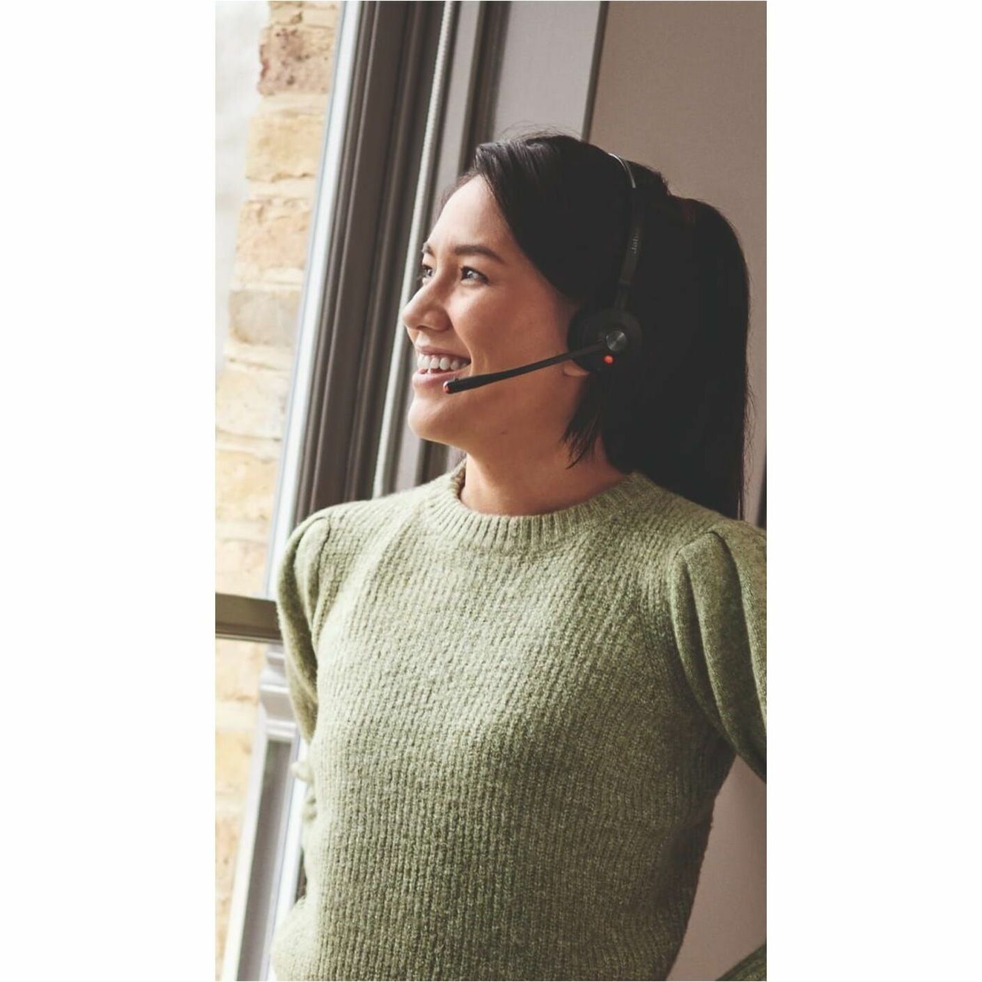 Professional using Jabra Engage 55 SE headset while working near window-alternate-image4