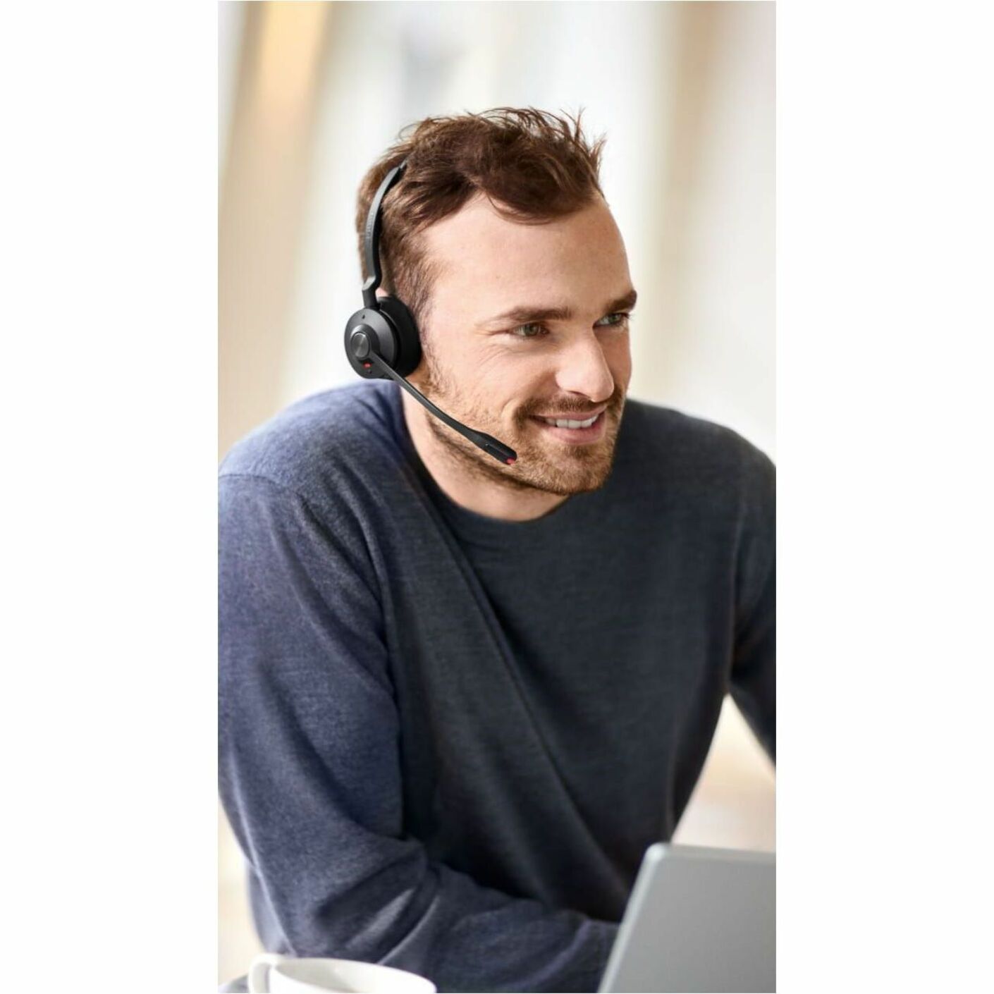 Professional engaged in virtual meeting wearing Jabra Engage 55 SE headset-alternate-image5