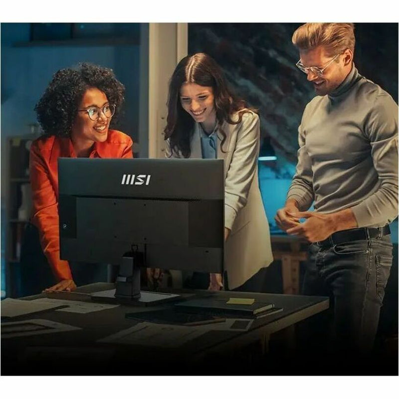 Team members collaborating around MSI PRO MP245G monitor