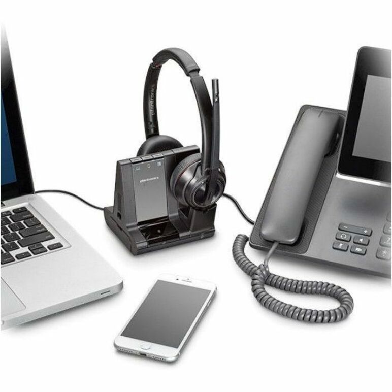 Poly Savi 8220-M headset shown in a modern office setup with laptop, smartphone, and desk phone connectivity-alternate-image3