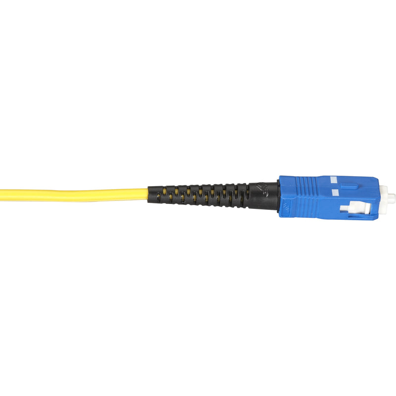 Close-up view of Black Box single-mode fiber optic cable showing yellow cable jacket and blue SC connector with black strain relief