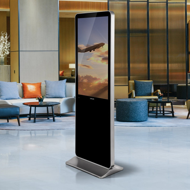 Digital kiosk displaying aircraft sunset scene in luxury hotel lounge setting with designer furniture